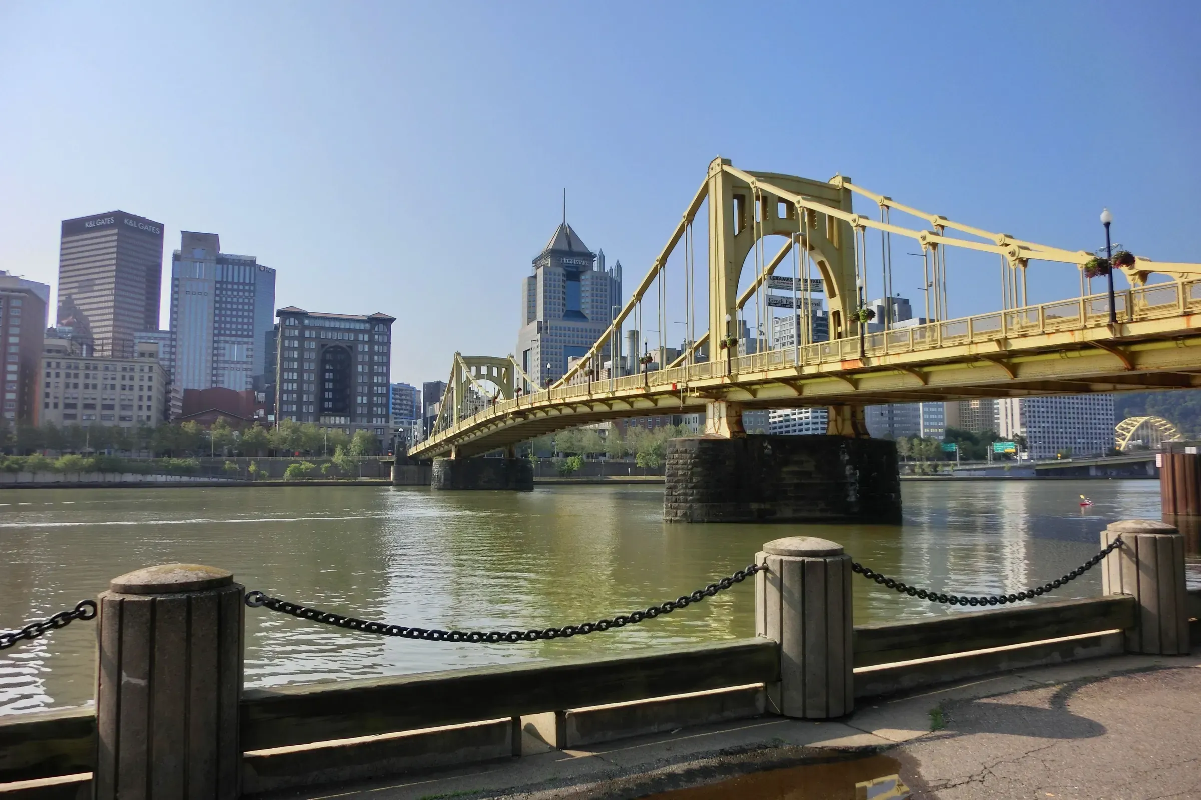 A yellow bridge across the river into downtown Pittsburgh